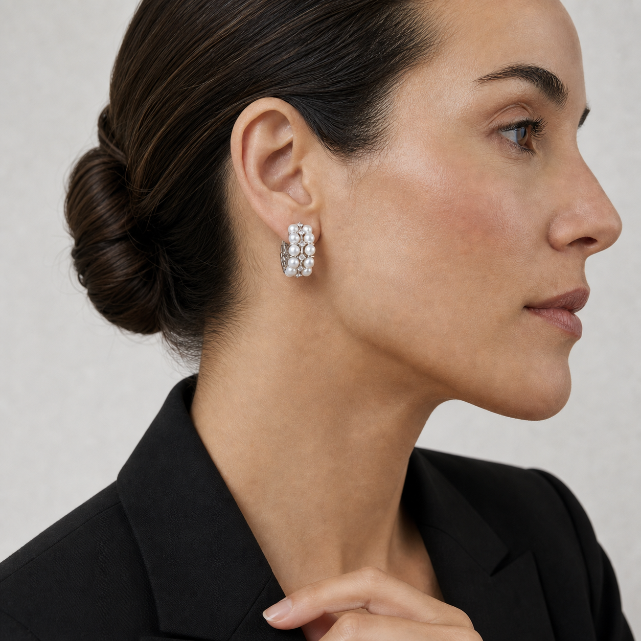 Model wearing Crystal Pearl Hoop Earrings in a modern studio portrait